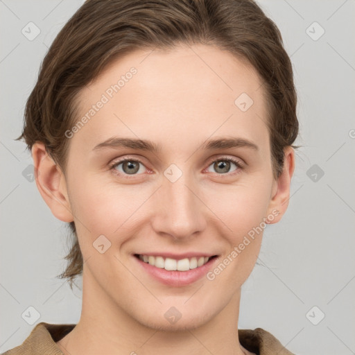 Joyful white young-adult female with medium  brown hair and grey eyes