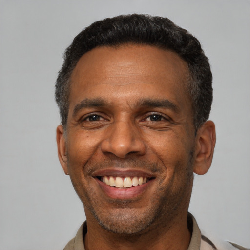 Joyful latino adult male with short  black hair and brown eyes