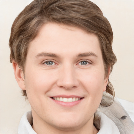 Joyful white young-adult female with short  brown hair and grey eyes