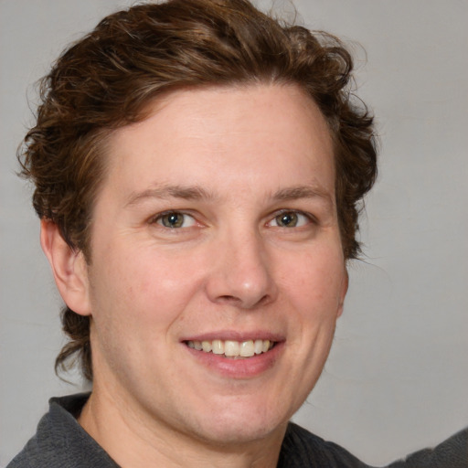 Joyful white adult female with medium  brown hair and blue eyes