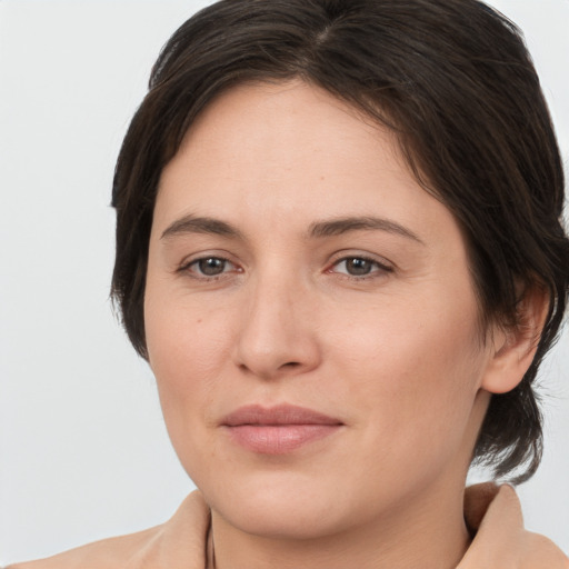 Joyful white young-adult female with medium  brown hair and brown eyes