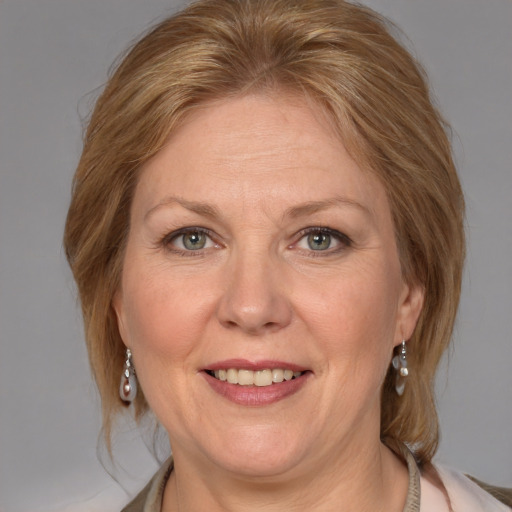 Joyful white adult female with medium  brown hair and blue eyes