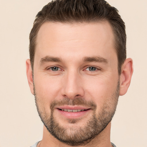 Joyful white young-adult male with short  brown hair and brown eyes