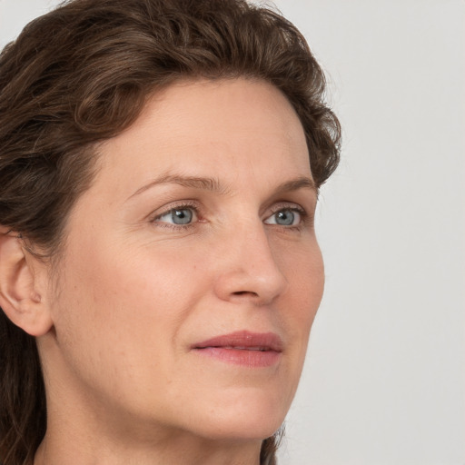 Joyful white adult female with short  brown hair and grey eyes