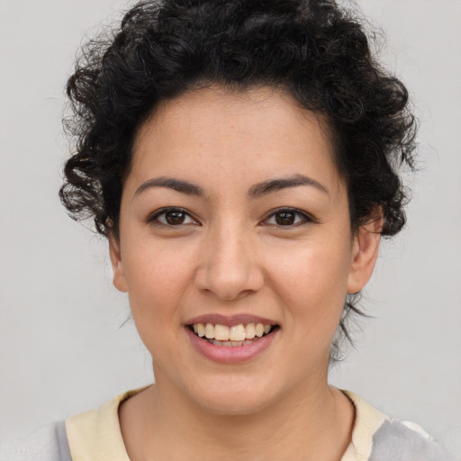 Joyful latino young-adult female with medium  brown hair and brown eyes