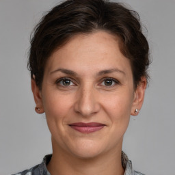 Joyful white adult female with medium  brown hair and brown eyes