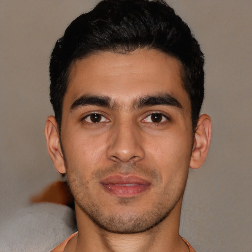 Joyful white young-adult male with short  black hair and brown eyes