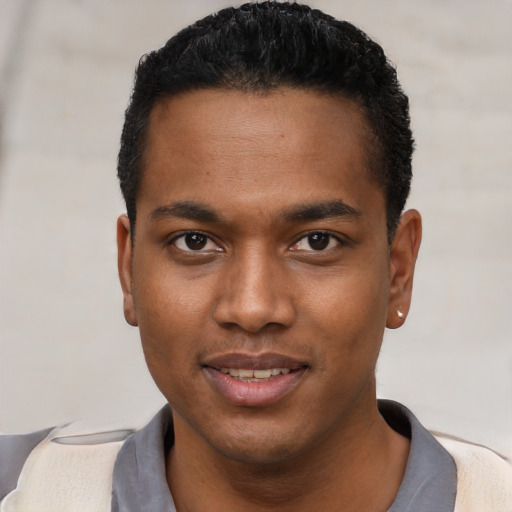 Joyful black young-adult male with short  black hair and brown eyes
