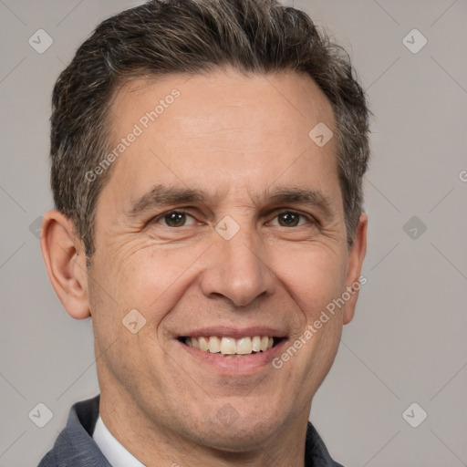 Joyful white adult male with short  brown hair and brown eyes