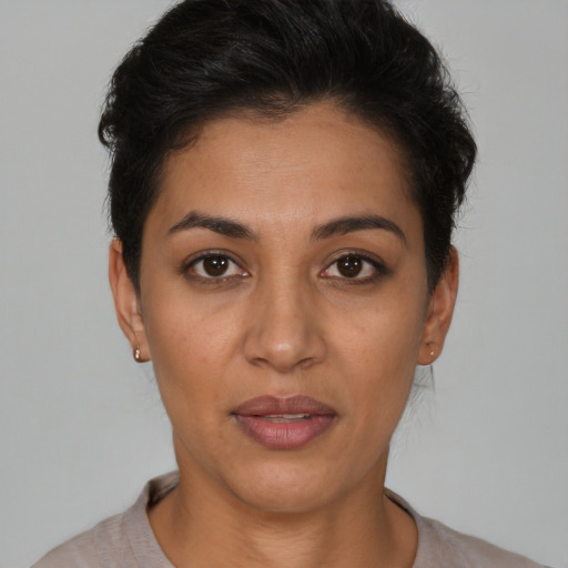 Joyful latino young-adult female with short  brown hair and brown eyes