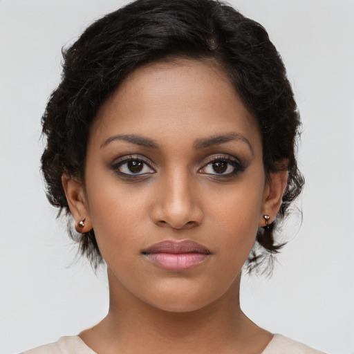 Joyful latino young-adult female with medium  brown hair and brown eyes