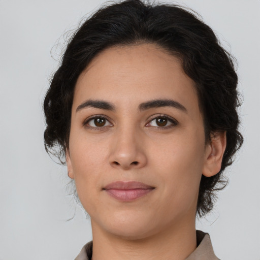 Joyful latino young-adult female with medium  brown hair and brown eyes