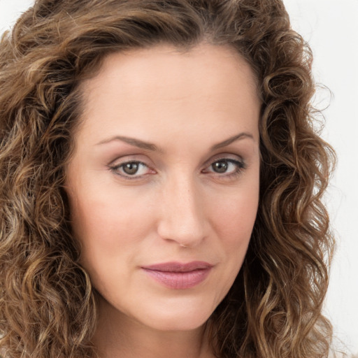 Joyful white young-adult female with long  brown hair and green eyes