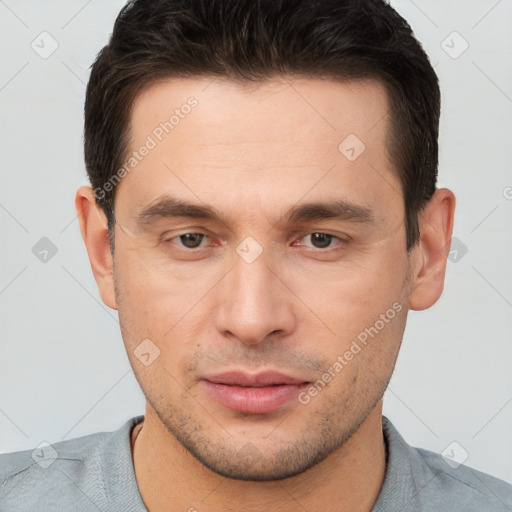 Joyful white young-adult male with short  brown hair and brown eyes