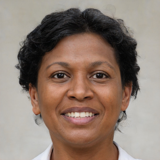 Joyful latino adult female with short  brown hair and brown eyes