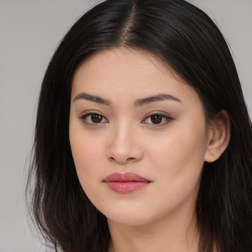 Joyful asian young-adult female with long  brown hair and brown eyes