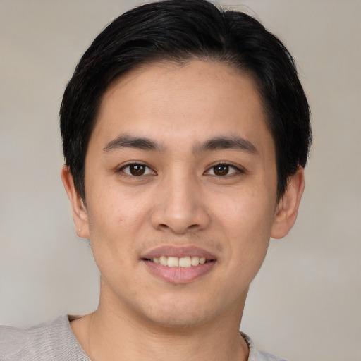 Joyful white young-adult male with short  black hair and brown eyes