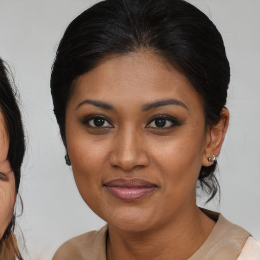 Joyful black young-adult female with medium  brown hair and brown eyes
