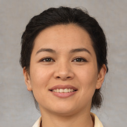 Joyful latino young-adult female with medium  brown hair and brown eyes