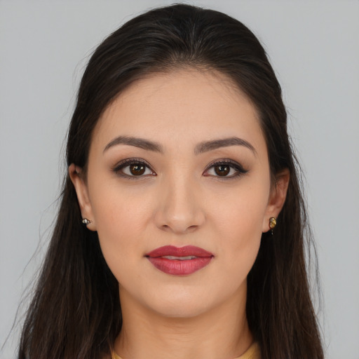 Joyful white young-adult female with long  brown hair and brown eyes