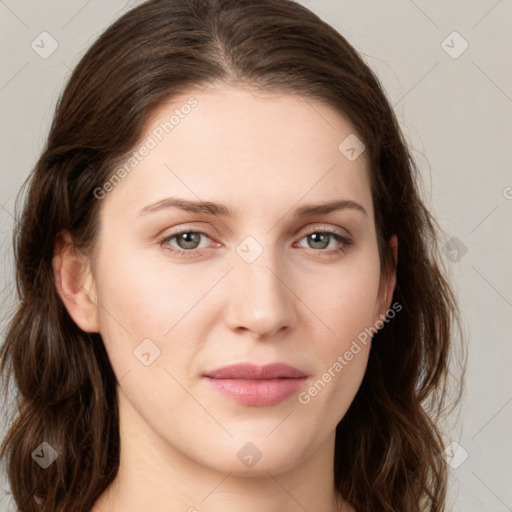 Joyful white young-adult female with long  brown hair and green eyes