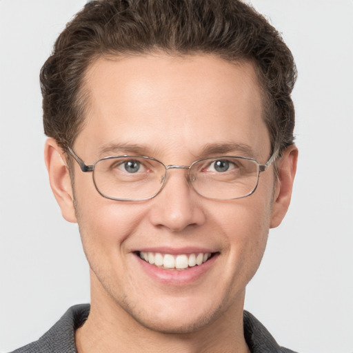 Joyful white adult male with short  brown hair and grey eyes