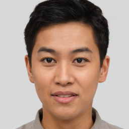 Joyful asian young-adult male with short  black hair and brown eyes