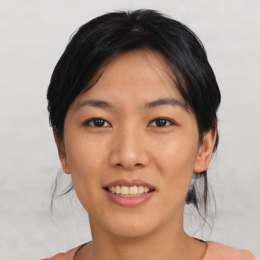 Joyful asian young-adult female with short  black hair and brown eyes