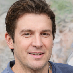Joyful white adult male with short  brown hair and grey eyes