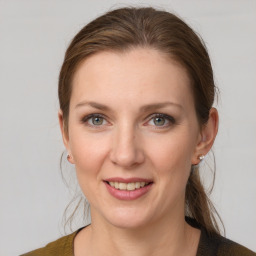 Joyful white young-adult female with medium  brown hair and grey eyes