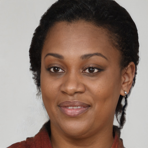 Joyful black young-adult female with medium  brown hair and brown eyes
