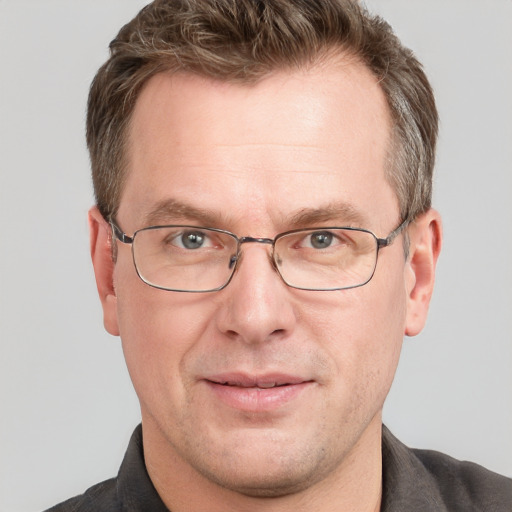 Joyful white adult male with short  brown hair and grey eyes