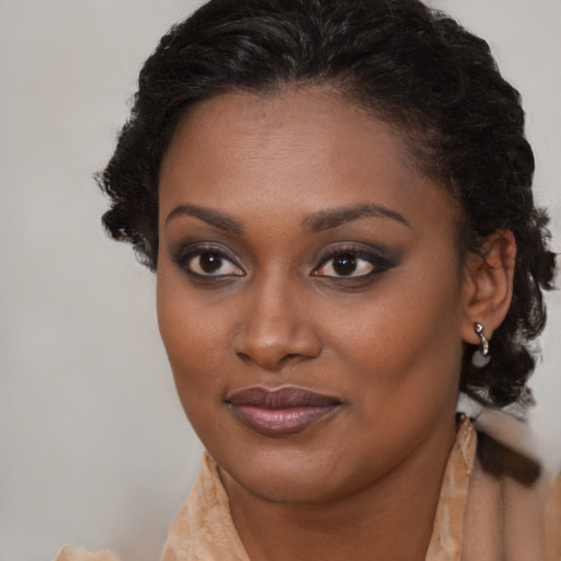 Joyful black young-adult female with long  brown hair and brown eyes
