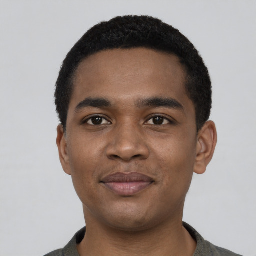 Joyful black young-adult male with short  black hair and brown eyes
