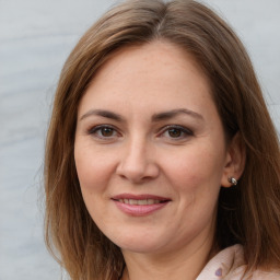 Joyful white adult female with medium  brown hair and brown eyes