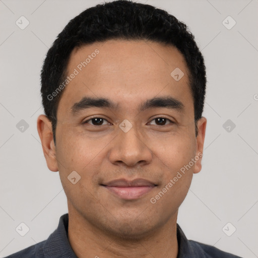 Joyful latino young-adult male with short  black hair and brown eyes