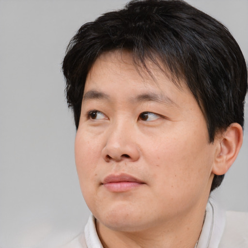 Neutral asian adult male with short  brown hair and brown eyes