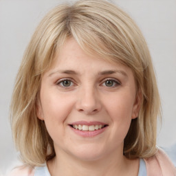 Joyful white young-adult female with medium  brown hair and blue eyes