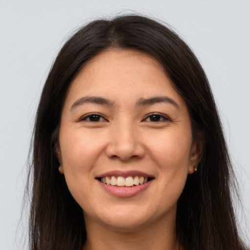 Joyful white young-adult female with long  brown hair and brown eyes