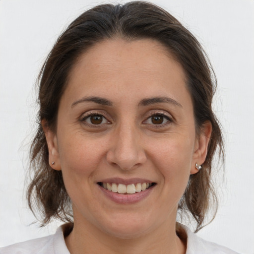 Joyful white adult female with medium  brown hair and brown eyes