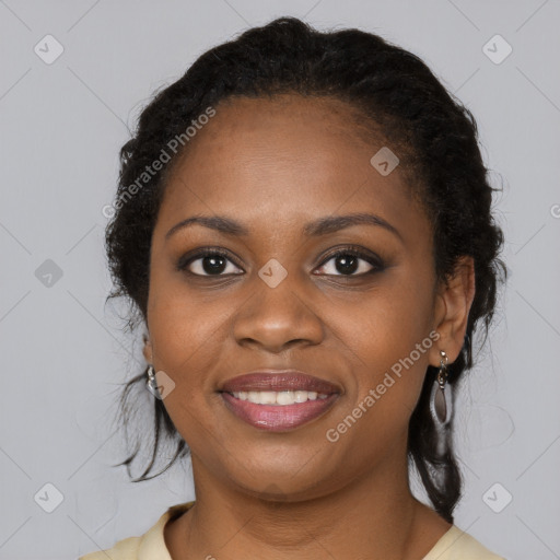 Joyful black young-adult female with long  brown hair and brown eyes