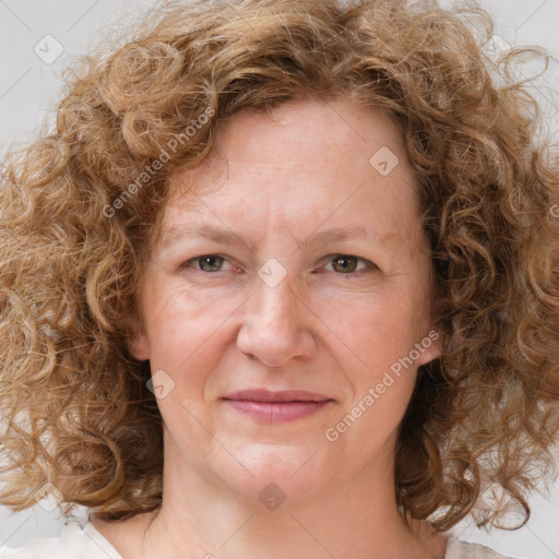 Joyful white adult female with medium  brown hair and blue eyes