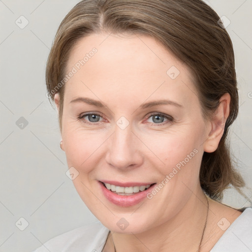 Joyful white young-adult female with medium  brown hair and grey eyes