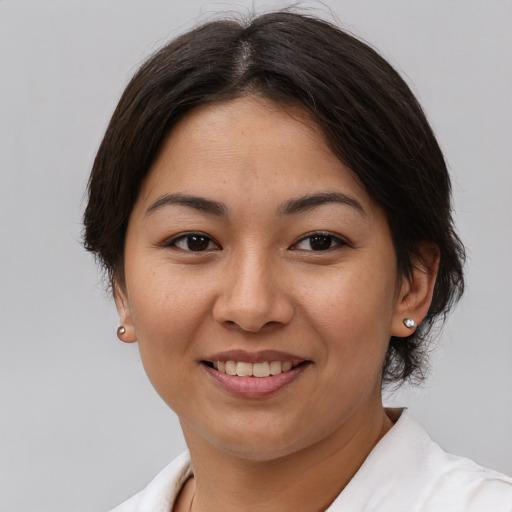 Joyful asian young-adult female with short  brown hair and brown eyes