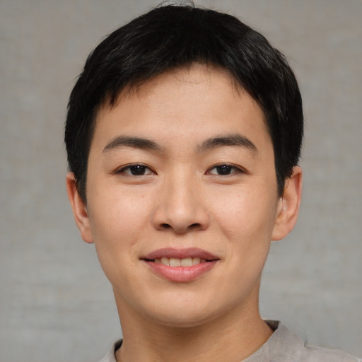 Joyful asian young-adult male with short  brown hair and brown eyes