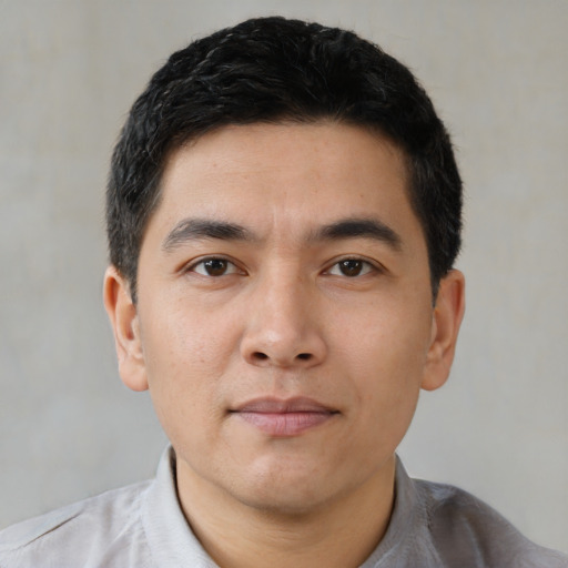 Joyful asian young-adult male with short  black hair and brown eyes