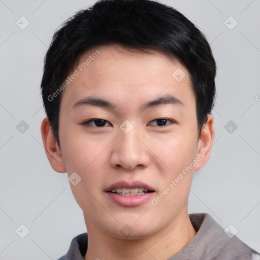 Joyful asian young-adult male with short  black hair and brown eyes