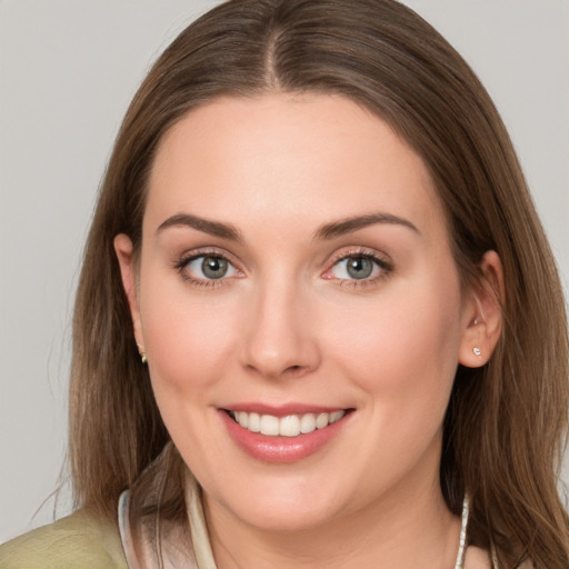 Joyful white young-adult female with long  brown hair and grey eyes