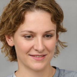 Joyful white young-adult female with medium  brown hair and blue eyes