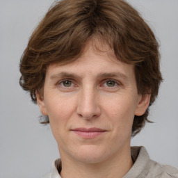 Joyful white adult female with medium  brown hair and grey eyes